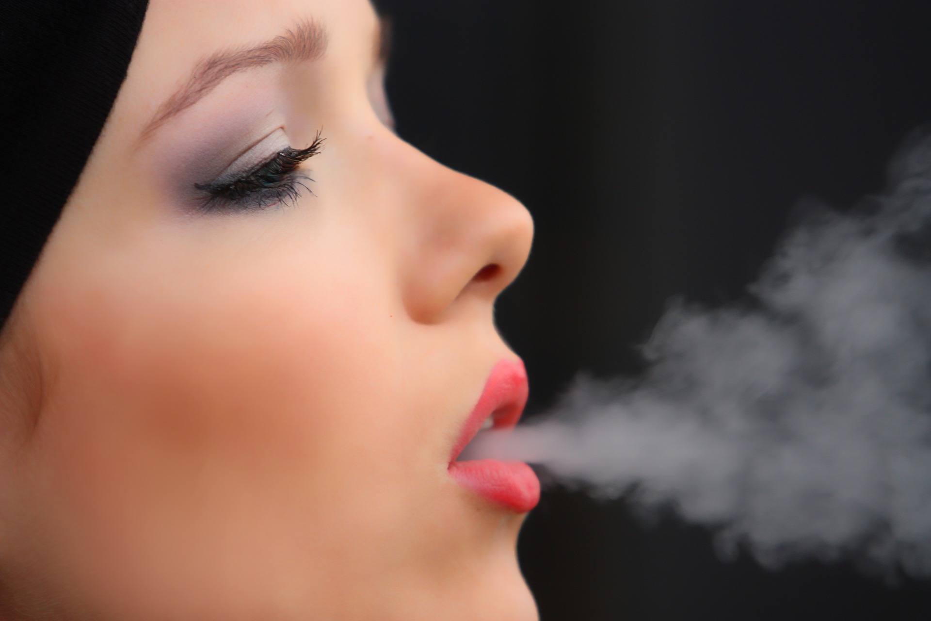 female exhaling smoke